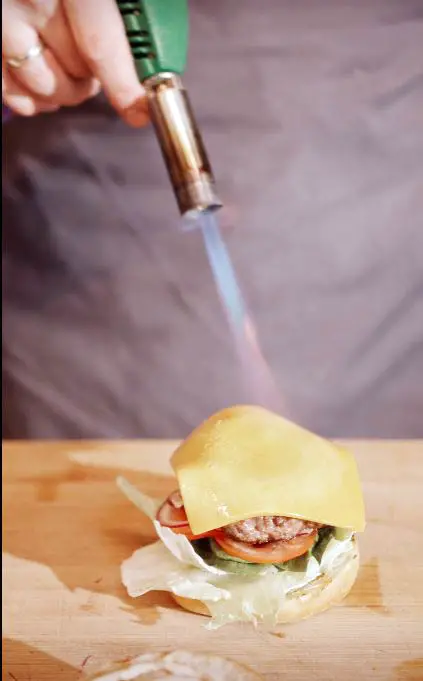 using a blowtorch to cook