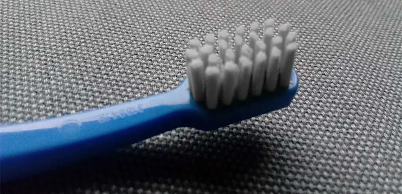 Why do dentists recommend soft toothbrushes?